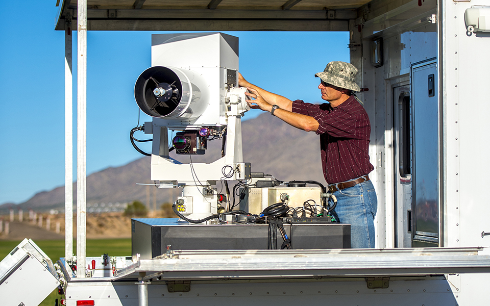A Boeing employee configures a High Energy Laser